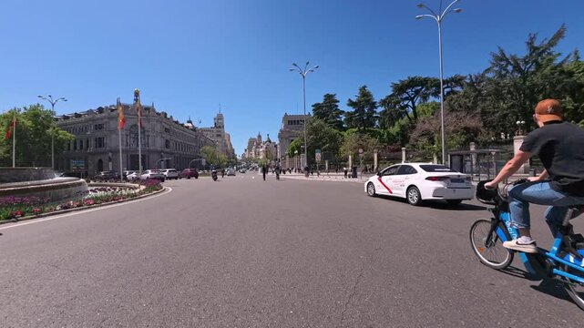 4K Time Lapse: Personal perspective POV of a man riding his motorbike through the Gran V&iacute;a street in Madrid from Fuente de Cibeles to Callao Square on a sunny day with buses, taxis and cars, Madrid