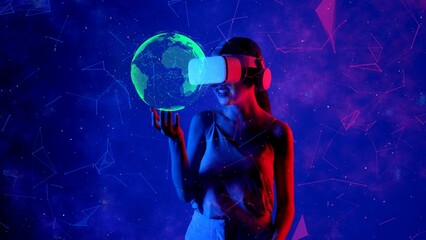 Smiling woman in VR turning on holding green world looking through metaverse blue neon digital universe rotating global on virtual space fantastic exploration nebula vibrant meta world. Hallucination.