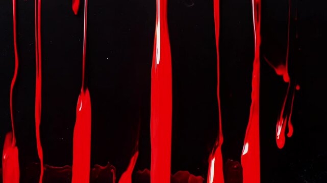Red paint or blood dripping on black background