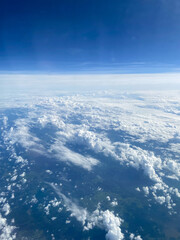 Fototapeta premium above view of clouds over earth and dark blue sky