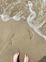 foot and footprints on sand beach at Courish Spit