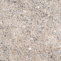 surface of old concrete with black pebble road
