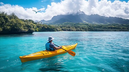 A man in a yellow kayak paddles through turquoise waters under a blue sky, surrounded by tropical beauty.