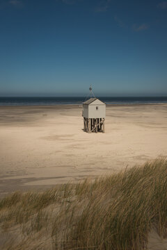 isolated wooden lifeguard hut on beach on the island of Terschelling, the Netherlands
