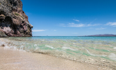 Sunny summer vacation morning in EL TECOLOTE BEACH, with mountains and the crystal clear water of the Sea of Cortes, infront of the ESPIRITU SANTO Island. Seascape of La Paz BCS Mexico. Panoramic View