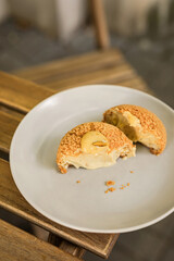 Close-up of a choux au craquelin french pastry or cream puff with pistachio filling cut in half