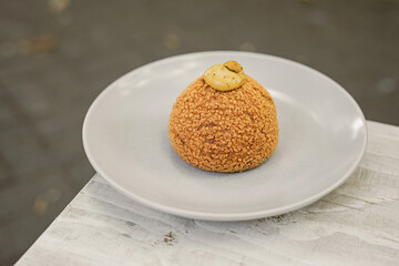 Choux au Craquelin french pastry or cream puff dessert on a plate