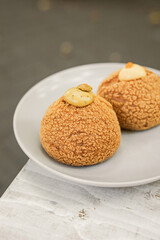 Choux au Craquelin french pastry or cream puff dessert on a plate