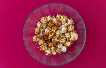 bowl of popcorn with a pink background
