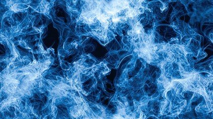 Obraz premium A close-up of blue smoke on a dark background with lots of visible smoke emanating from it