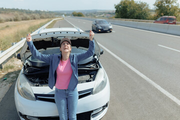 Annoyed Young Woman Standing Beside Car Breakdown on Highway