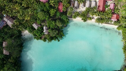 Beach with palmtrees and blue crystal clear water, Indonesia