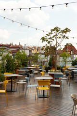 Modern Rooftop Cafe with Colorful Chairs and City Views