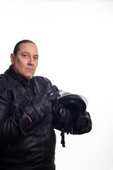 Biker, an adult man wearing black biker clothing and holding a helmet in front of a white background, selective focus.