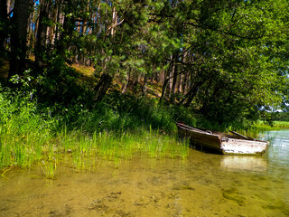 Boat on Wdzydzkie lake coast.