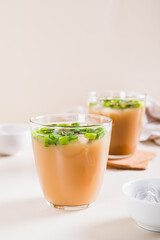 Spring iced scallion latte in glasses on the table vertical view