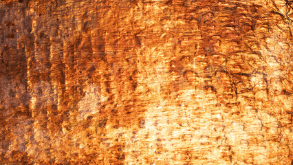 Close up of a rough textured weathered metal surface showing signs of age and distress