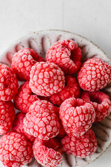 frozen raspberries in a grey bowl