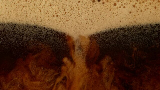 Super Slow Motion Detail Shot of Pouring Fresh Creamy Coffee at 1000fps.