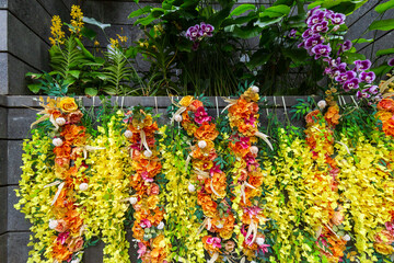 A vibrant and colorful floral display featuring an array of yellow and orange blossoms with lush greenery