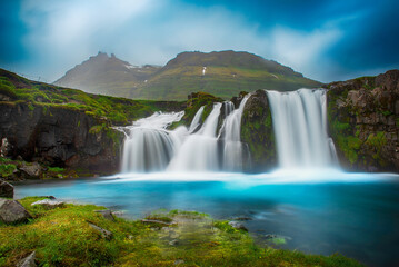 View to the Kirkjufell waterfall at summer. Kirkjufellsfoss waterfall, Iceland, Europe.