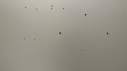 Holes drilled in a concrete wall covered with plaster. Concrete texture for background. Abstract concrete surface pattern as background