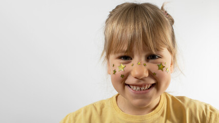 Smiling little girl with stars painting on cheeks mockup