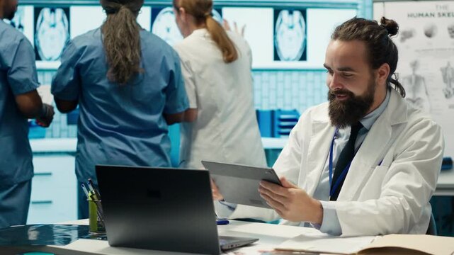 Cheerful confident doctors and nurses finding right treatment plan for a diagnosis, competent healthcare industry workers. Medical staff smiling and clapping hands, good news in a cabinet. Camera A.