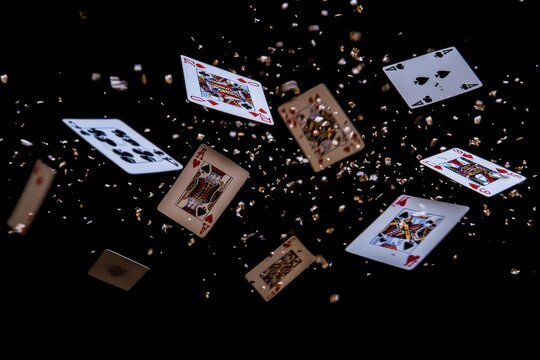 A pile of playing cards is flying through the air