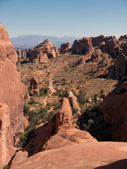 Fototapeta premium Climbing on massive red rock cliff in Arches National Park, Utah