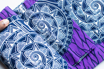top view of purple and white ankara fabric, flatlay of nigerian wax cloth, rumpled purple and white ankara material