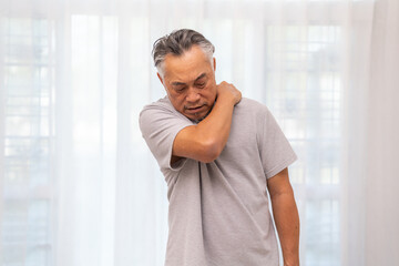 Sick unhappy senior adult elderly man touching her muscle injury Lower back suffering from muscles back pain at home.physical injury and healthcare problem