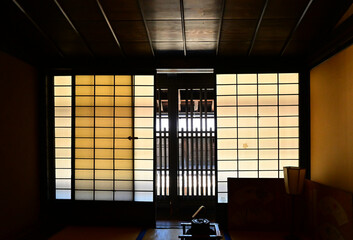 Fototapeta premium Japanese house, dark room, bright outside, through lattice, shoji, iron kettle.