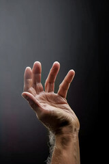 A hand is raised in the air with a white powdery substance on it