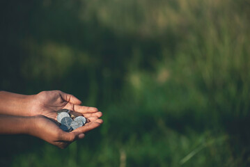 Financial Planner hand holding coin stack growing economy. Hands Protect Debt loan home financial plan coin stack. Money Investment advice plan budget banking insurance sustainable green background