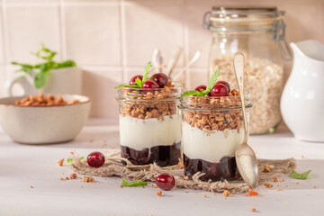 Sweet and healthy cherries granola in summer kitchen for lunch.