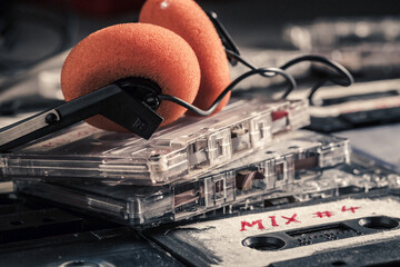 Retro pile of cassette tape and red headphones
