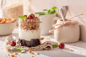 Healthy and homemade cherries granola in summer kitchen for lunch.