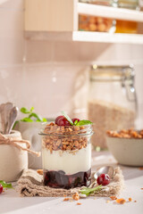 Sweet and delicious cherries granola with oat flakes in jar.