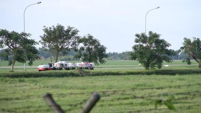 Baggage Towing Tractor is running in the Kualanamu international airport area, Deli Serdang, Sumatera, Indonesia.