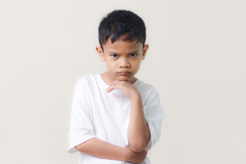 Thinking a cute little asian boy on white background. Child thinking. Education concept. Brainstorming and idea concept.