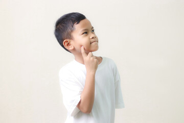 Thinking a cute little asian boy on white background. Child thinking. Education concept. Brainstorming and idea concept.