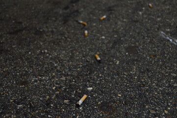 cigarette on asphalt road