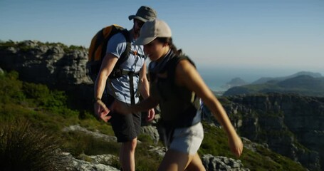 Mountains, hiking and couple holding hands, help and support partner on climbing rock, journey or backpacking. Cliff, teamwork assistance and people walking with freedom, adventure or explore nature