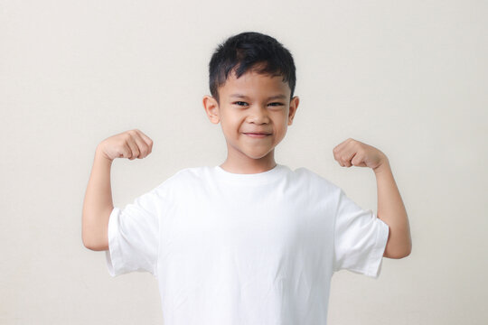 Happy Asian children showing her strong hands.