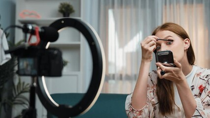 Woman influencer shoot live streaming vlog video review makeup prim social media or blog. Happy young girl with cosmetics studio lighting for marketing recording session broadcasting online.