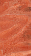 Glitter paint flow. Fluid spill. Defocused red color shimmering marble texture emulsion stream wave abstract art background.