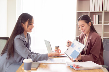 Obraz premium Asian woman pressing 2 hands on forehead feeling stressed, worried about bad financial business with documents and laptop on table