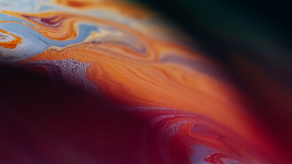 Oil fluid stain. Blur ink mix. Defocused blue orange color acrylic emulsion marble curve wave on dark abstract art background.