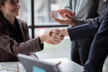 Business handshake for teamwork of business merger and acquisition,successful negotiate,hand shake,two businessman shake hand with partner to celebration partnership and business deal concept

